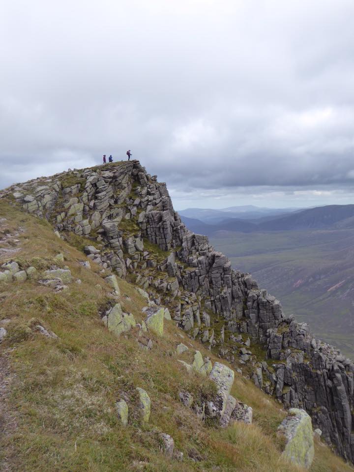 Trekkers stand at the summit of Sgor Goaith in the Cairngorms