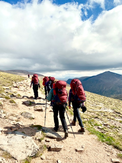 Female trekkers ascend mountain in the Cairngorms